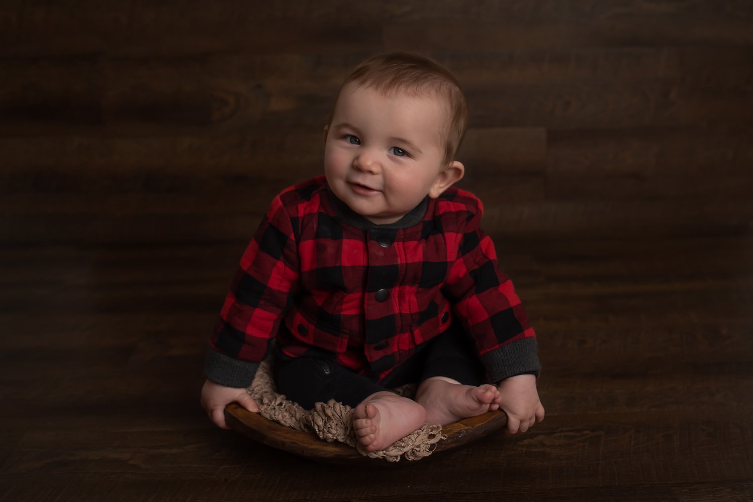 Milestone Photoshoot - Baby in plaid shirt smiling at the camera