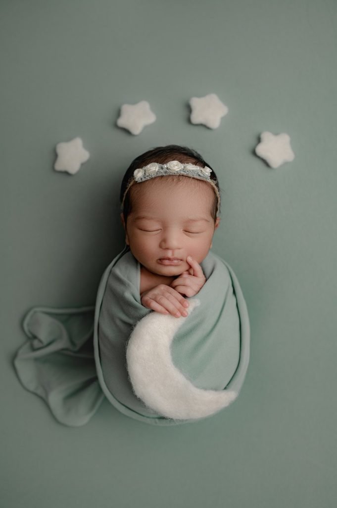 Newborn Baby Girl and White Stars In the Background