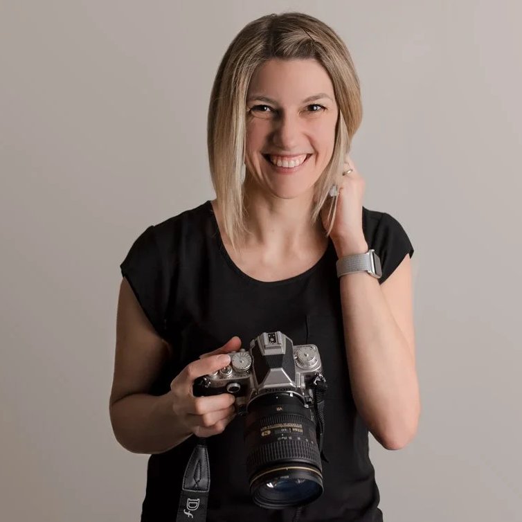Tanja Haller, maternity and newborn photographer in North Vancouver, holding her camera
