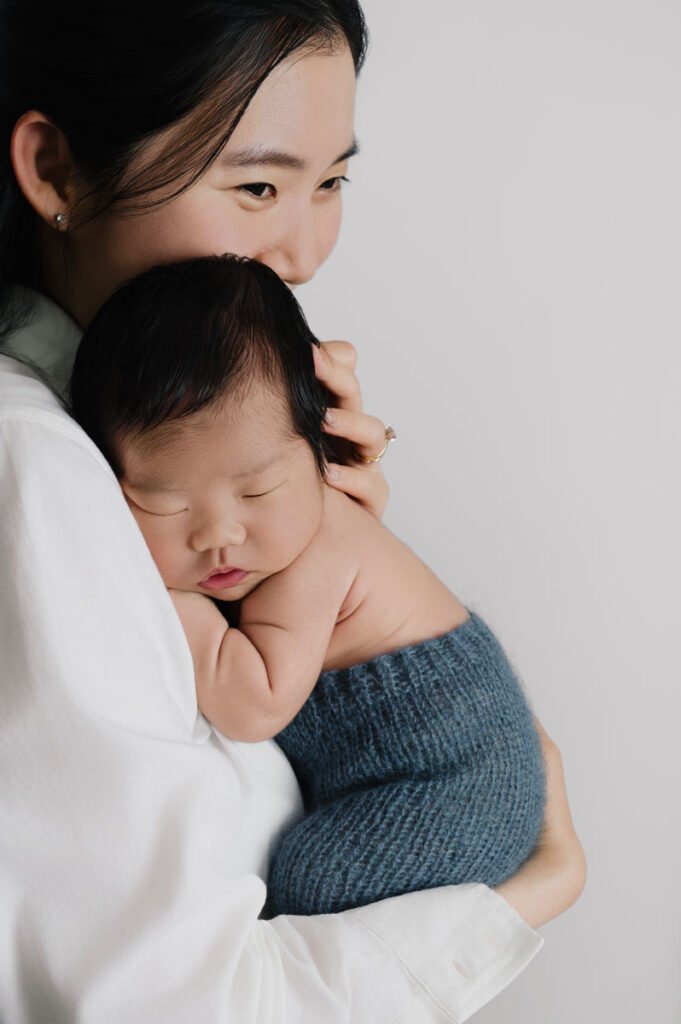 Mom holding her newborn baby in a North Vancouver studio