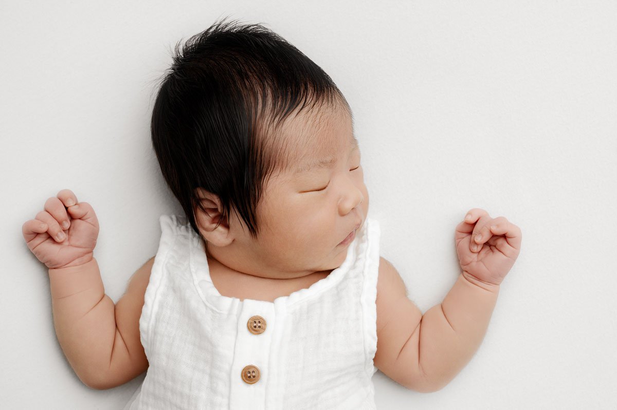 Natural newborn portrait on whites and creams