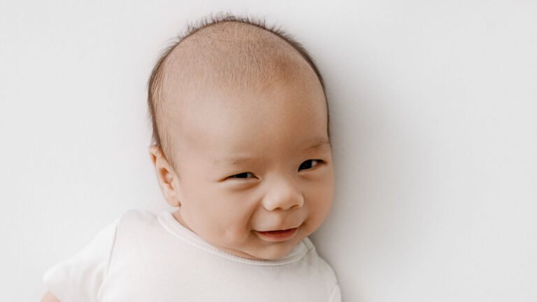 Older newborn baby looking at the camera